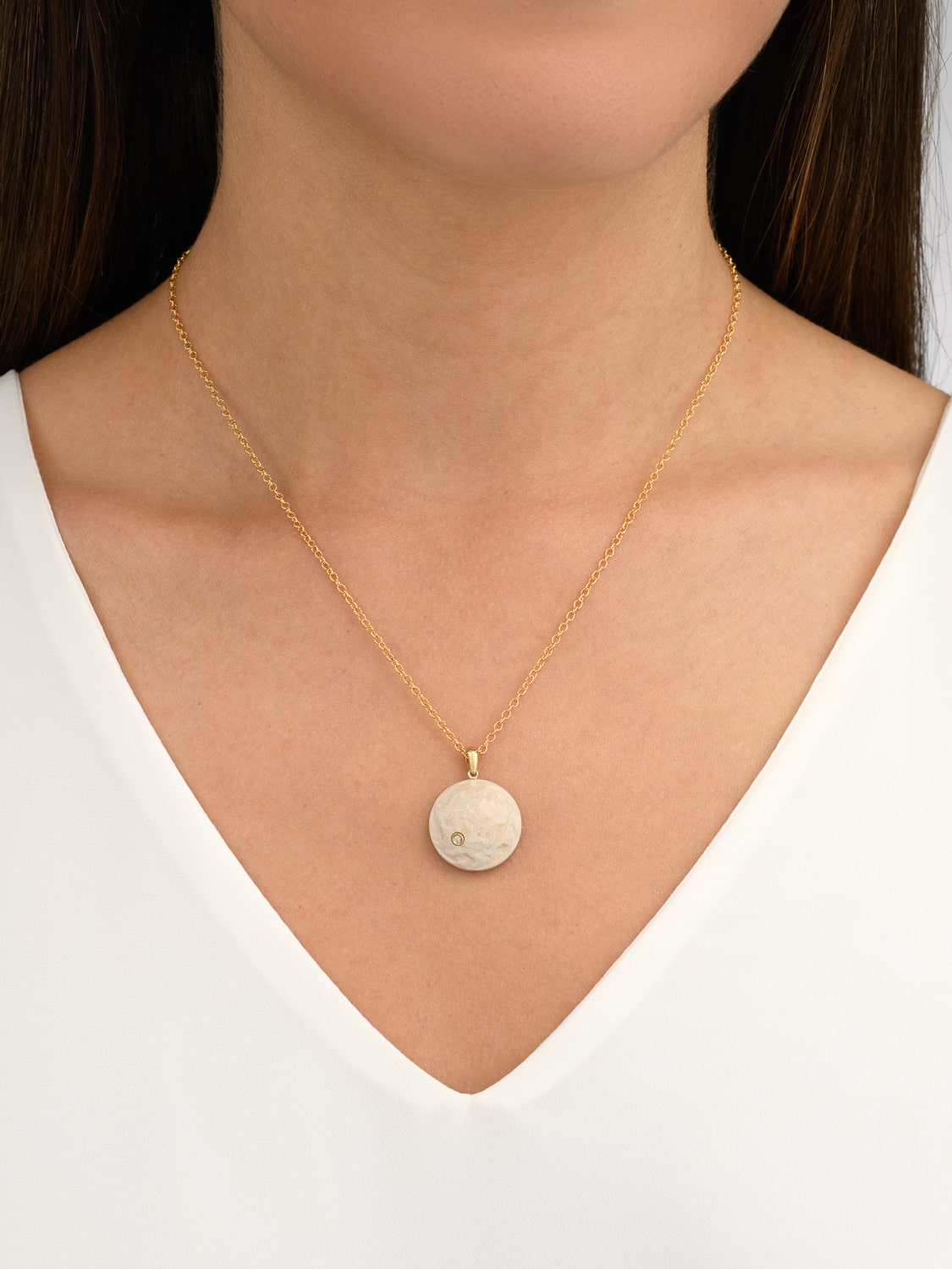 A stone pendant from the Temple Mount in the form of a diamond-encrusted coin